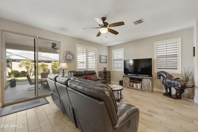 living room featuring ceiling fan and light hardwood / wood-style floors