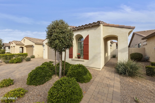 mediterranean / spanish home featuring a garage