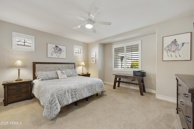 bedroom featuring light colored carpet and ceiling fan