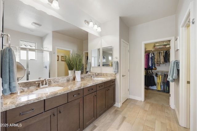 bathroom featuring vanity, an enclosed shower, and hardwood / wood-style floors