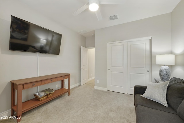 living room with light colored carpet and ceiling fan