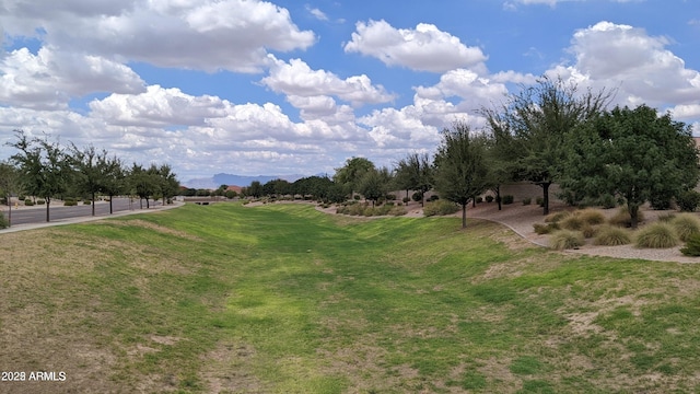 surrounding community featuring a lawn and a rural view