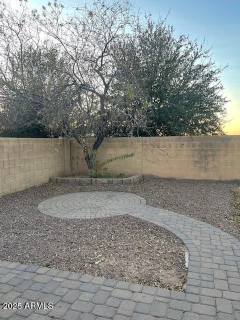 yard at dusk with a patio