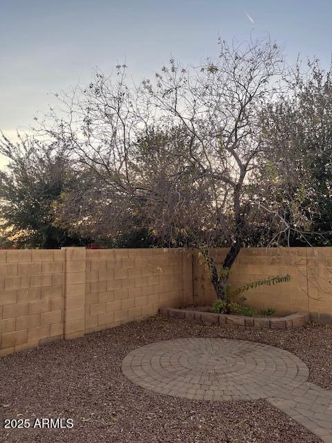 yard at dusk featuring a patio area