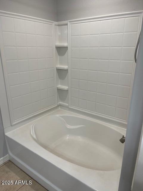 bathroom featuring tile patterned flooring and shower / bathtub combination