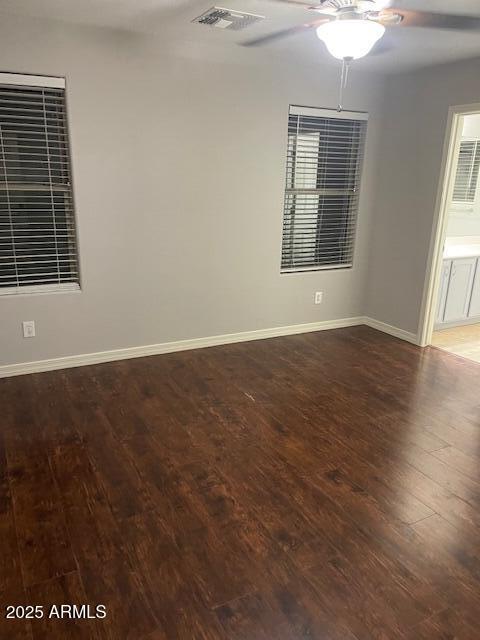 empty room with hardwood / wood-style flooring and ceiling fan