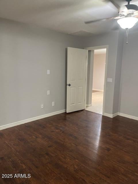 spare room with ceiling fan and dark hardwood / wood-style floors