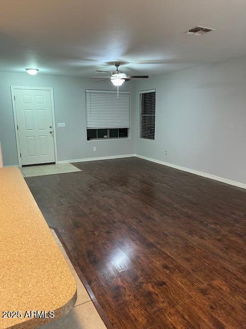 unfurnished living room featuring hardwood / wood-style floors and ceiling fan