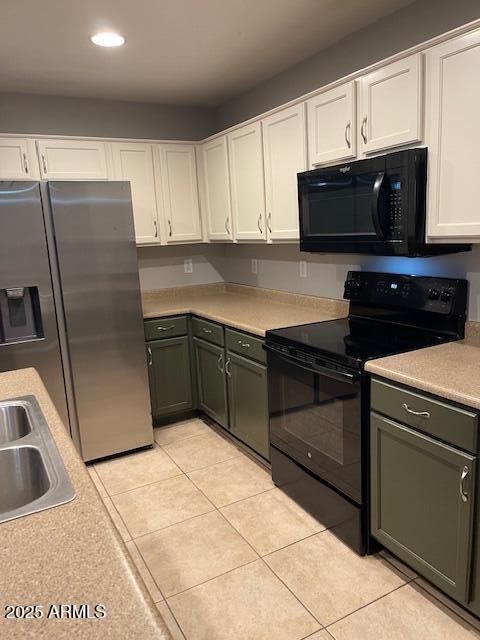 kitchen with white cabinetry, sink, light tile patterned flooring, and black appliances