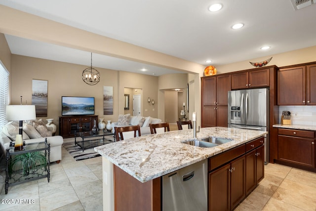 kitchen featuring open floor plan, visible vents, stainless steel appliances, and a sink