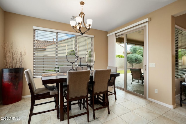 dining area featuring a chandelier, visible vents, baseboards, and light tile patterned floors