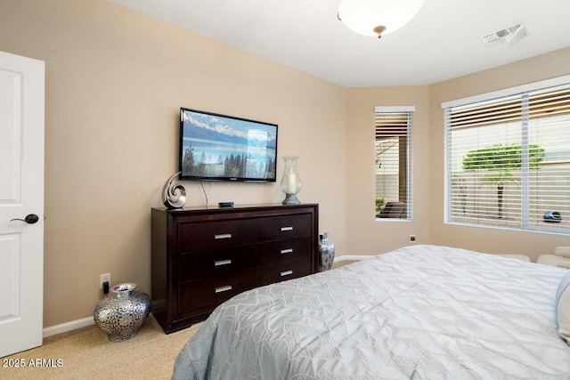 bedroom with visible vents, baseboards, and carpet flooring