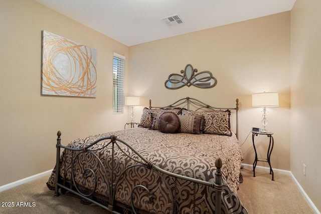 carpeted bedroom with visible vents and baseboards