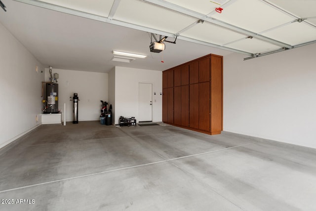 garage featuring gas water heater and a garage door opener