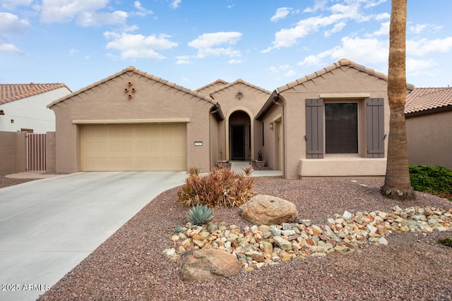 mediterranean / spanish-style home featuring fence, a garage, driveway, and stucco siding