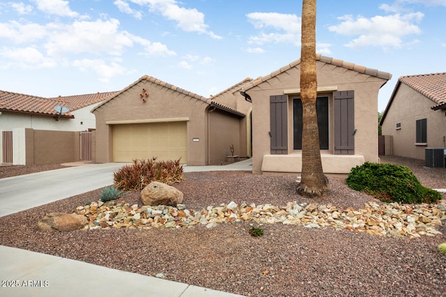 view of front of home with fence, driveway, an attached garage, stucco siding, and a tile roof