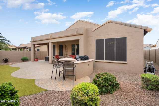 back of property featuring a patio, a fenced backyard, and stucco siding