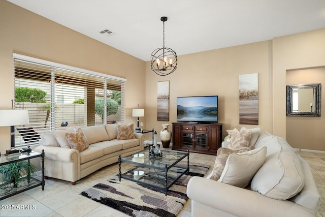 living room with light tile patterned floors, visible vents, baseboards, and a notable chandelier