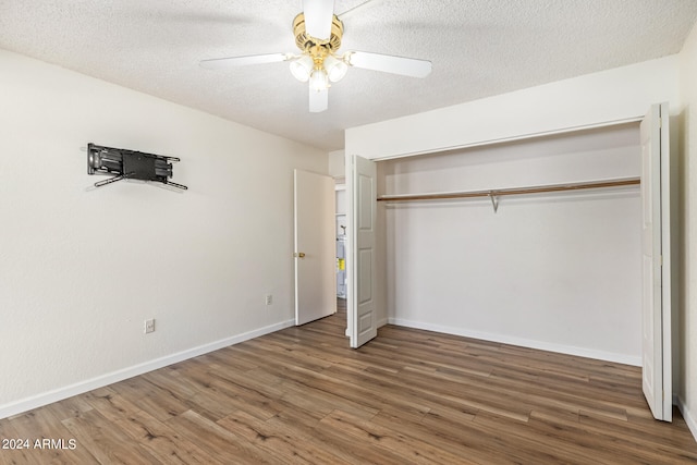 unfurnished bedroom with hardwood / wood-style floors, a closet, ceiling fan, and a textured ceiling