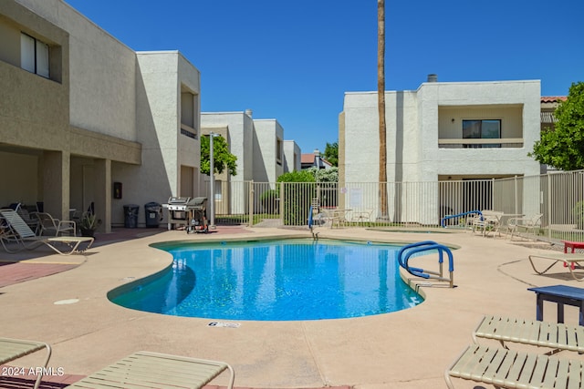 view of swimming pool with a patio area