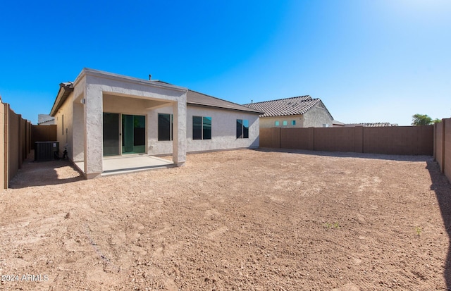 rear view of house featuring central air condition unit