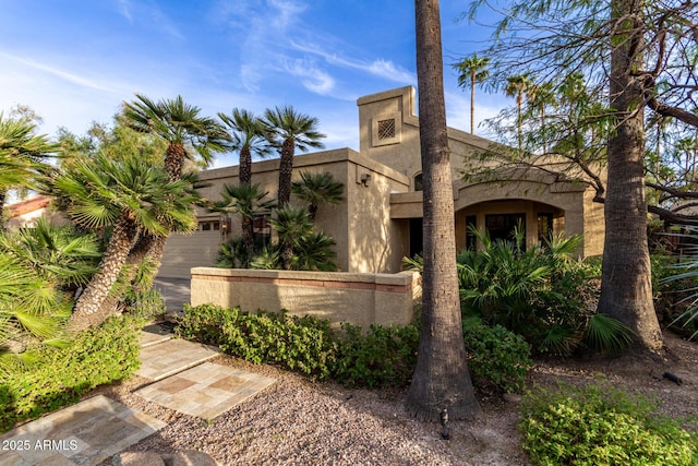 view of front of home featuring a garage and stucco siding