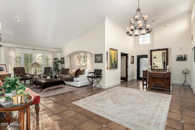 tiled foyer with plenty of natural light, arched walkways, a chandelier, and crown molding