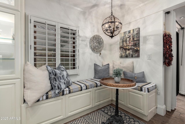 interior space featuring a chandelier, crown molding, and wood finished floors