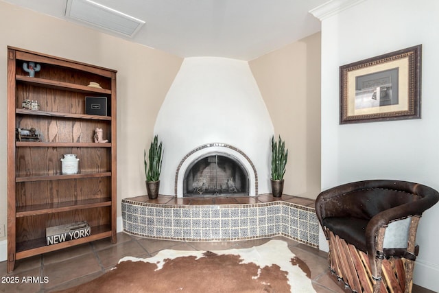 sitting room featuring visible vents, a fireplace, and tile patterned floors