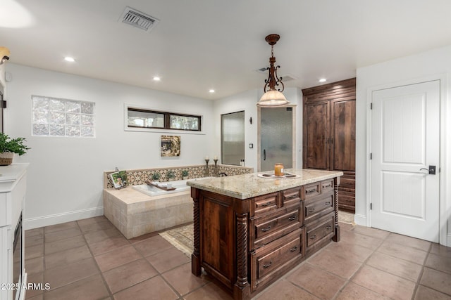 bathroom with a garden tub, recessed lighting, visible vents, and vanity