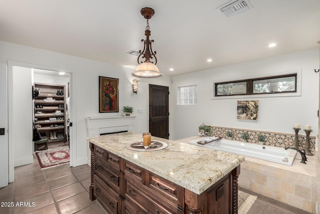 bathroom with a garden tub, recessed lighting, vanity, visible vents, and tile patterned floors