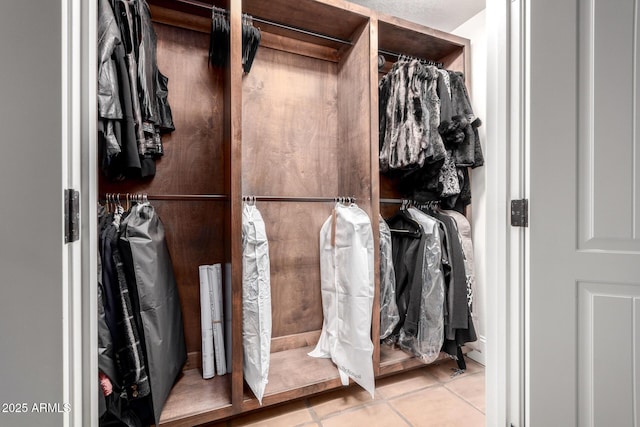 spacious closet with tile patterned floors