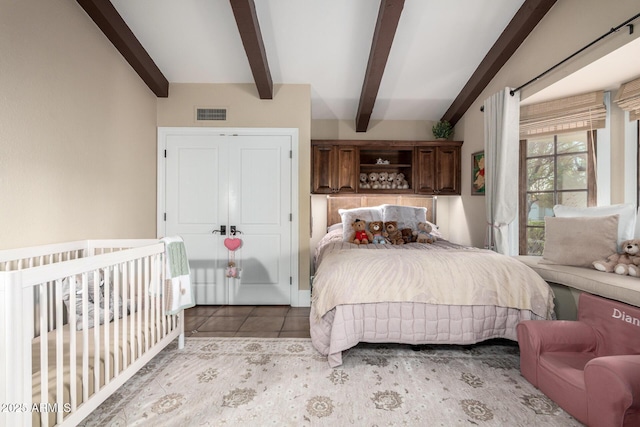 bedroom with visible vents, beamed ceiling, and tile patterned floors