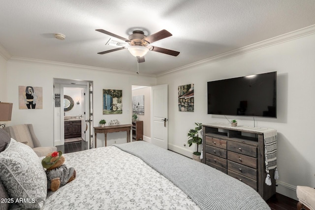 bedroom with baseboards, dark wood-type flooring, crown molding, and ensuite bathroom