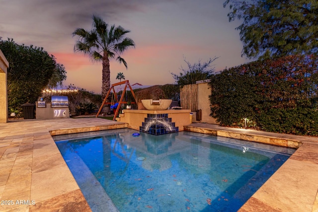 view of pool featuring a patio area, a fireplace, fence, and area for grilling