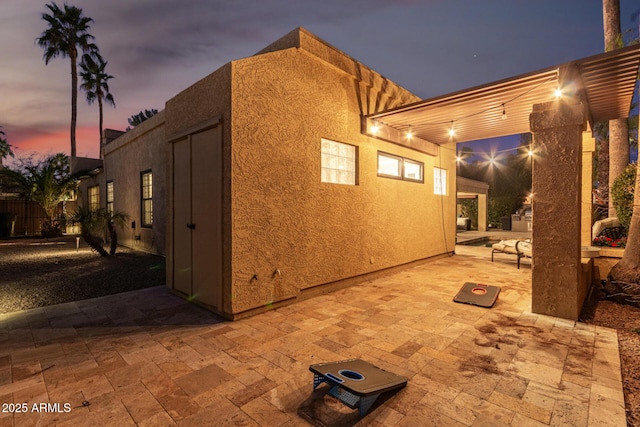 view of home's exterior with a patio and stucco siding