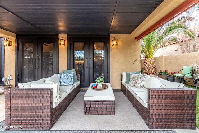 view of patio with an outdoor hangout area, french doors, and fence