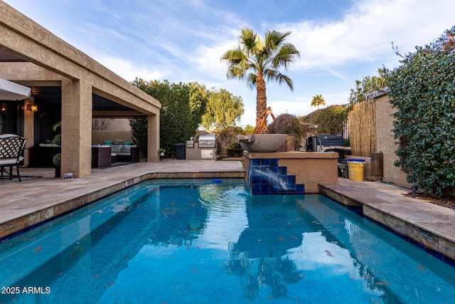 outdoor pool featuring fence, outdoor lounge area, a patio, and area for grilling