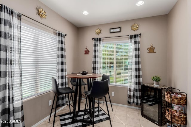 dining space with light tile patterned floors, recessed lighting, and baseboards