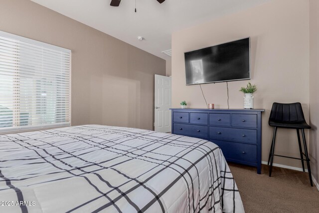 bedroom featuring a ceiling fan, baseboards, and dark carpet