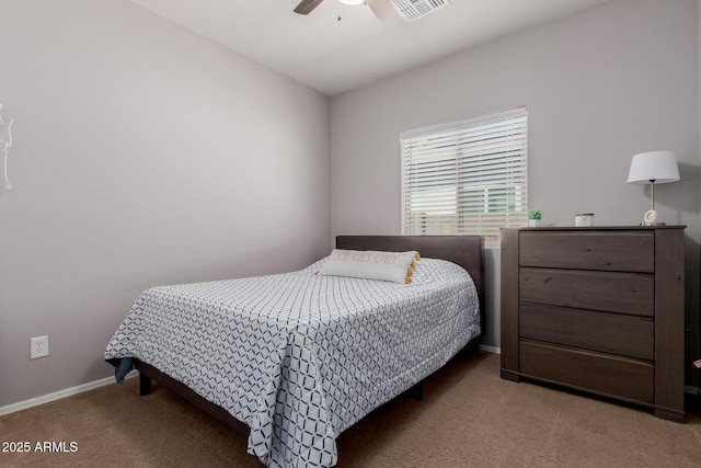 carpeted bedroom featuring visible vents, baseboards, and a ceiling fan