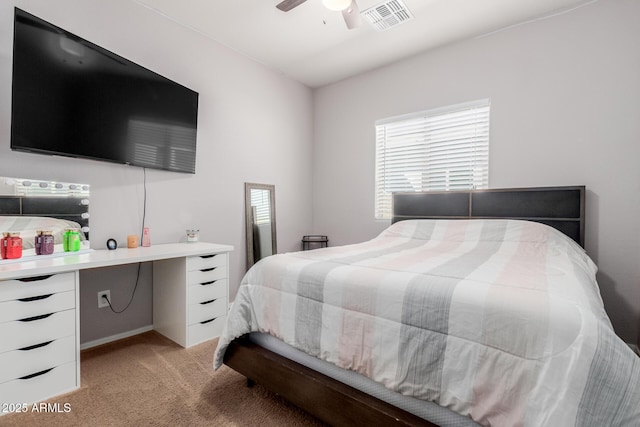 bedroom with visible vents, light colored carpet, and a ceiling fan