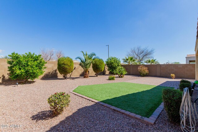 view of yard featuring a patio area and a fenced backyard