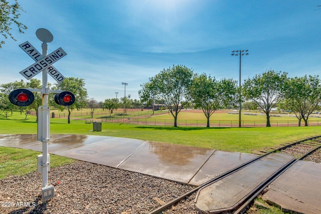 view of community with a yard and fence