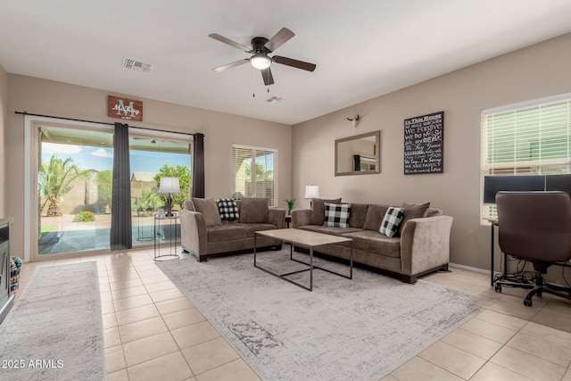 tiled living area featuring visible vents and a ceiling fan