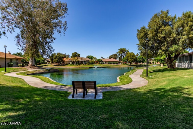 surrounding community featuring a lawn, a water view, and a residential view