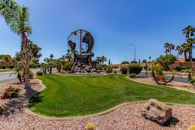 view of property's community with a lawn
