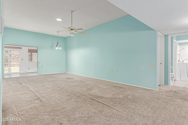 carpeted empty room with baseboards, ceiling fan, and a textured ceiling