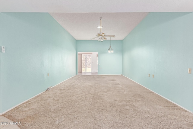 unfurnished room featuring baseboards, a ceiling fan, and carpet