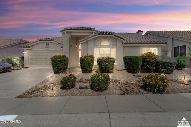 19102 N 91st St, Scottsdale, AZ 85255 - view of front of house featuring an attached garage, stucco siding, a tiled roof, and driveway